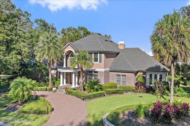 a living room with furniture a floor to ceiling window and a table