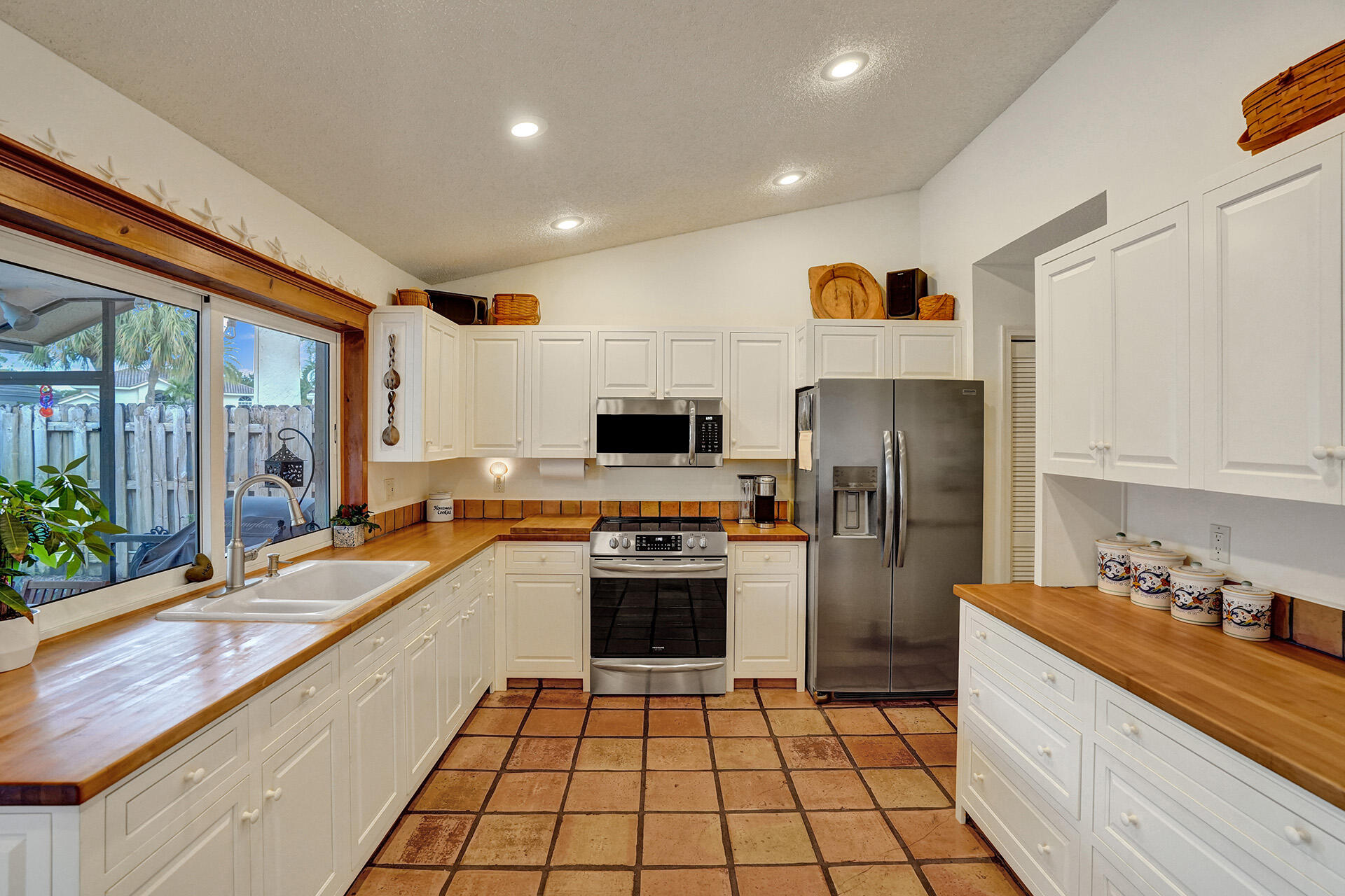 23258 Lago Mar Circle Boca Raton, FL 33433 - Photo 7 of 35 a large kitchen with a large counter top appliances and cabinets