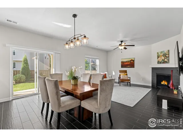 a view of a dining room with furniture wooden floor and chandelier