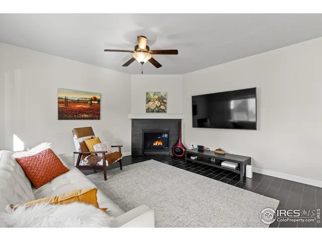 a living room with furniture flat screen tv and a fireplace