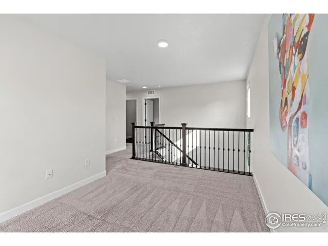 a view of hallway with wooden floor