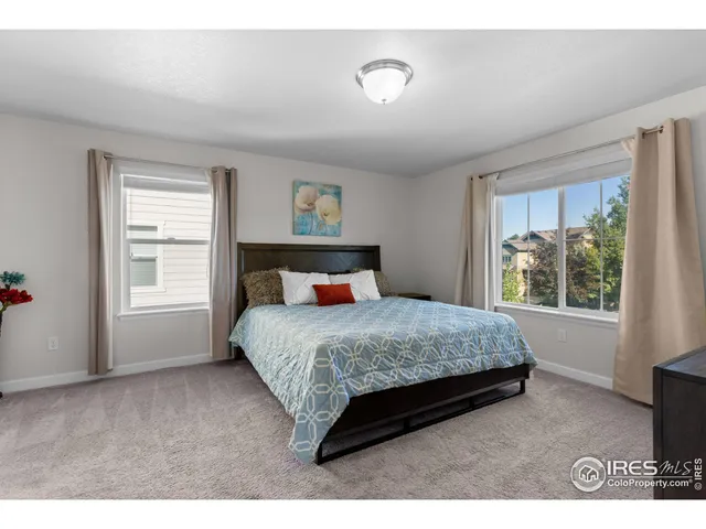 a bedroom with a bed lamp and window