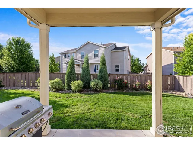 a aerial view of a house with a big yard and potted plants