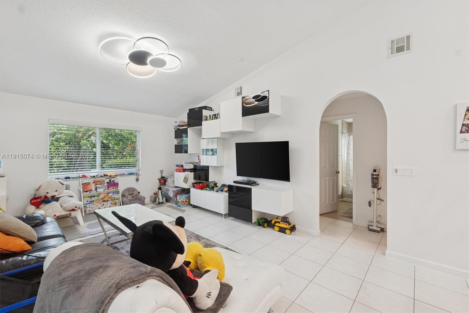1510 Southwest 96th Terrace Davie, FL 33324 - Photo 16 of 28 a living room with furniture and a flat screen tv