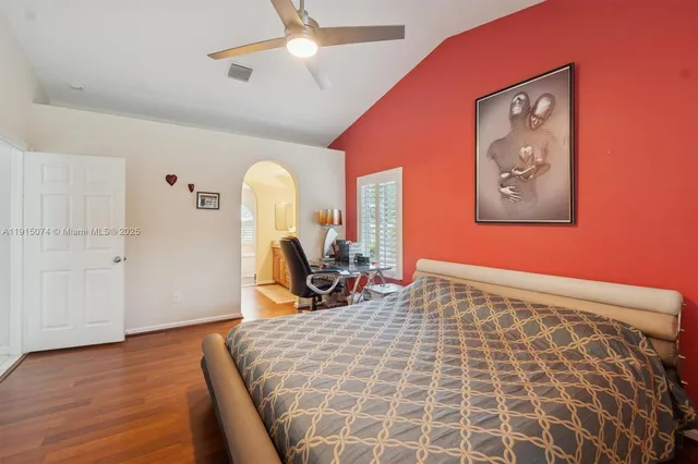 a bed room with a bed and a painting on the wall