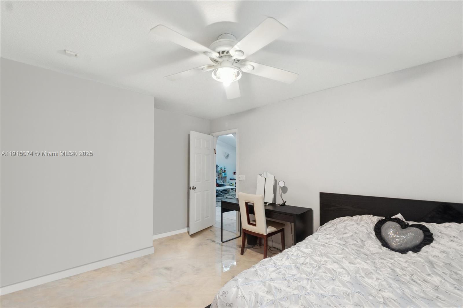 1510 Southwest 96th Terrace Davie, FL 33324 - Photo 23 of 28 a bedroom with a bed and a chandelier