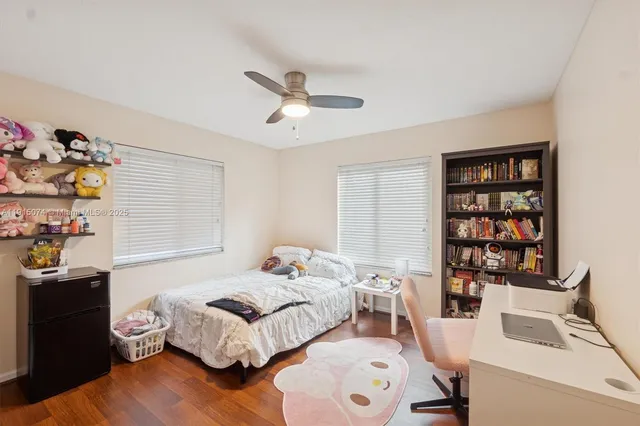 a bedroom with a bed and a bookshelf