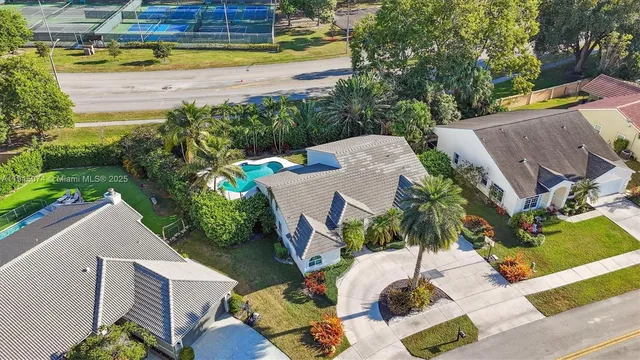 an aerial view of a house with a yard basket ball court and outdoor seating
