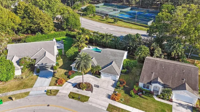 an aerial view of residential house with outdoor space and swimming pool