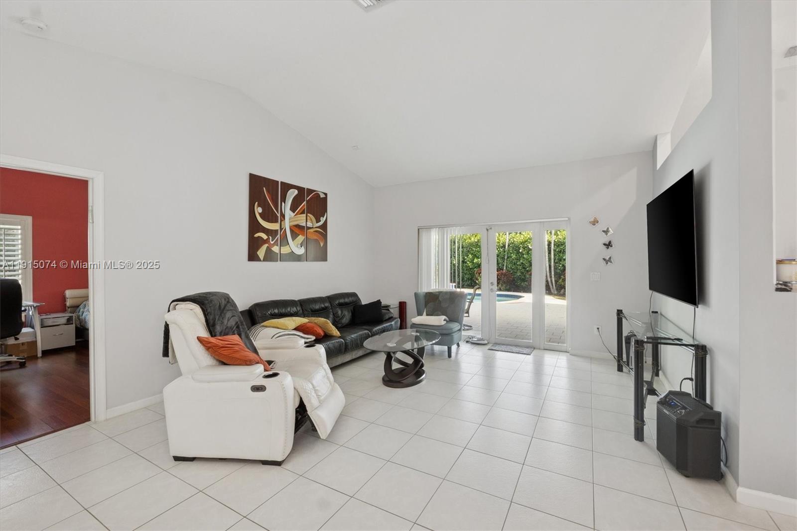 1510 Southwest 96th Terrace Davie, FL 33324 - Photo 8 of 28 a living room with furniture a flat screen tv and a window