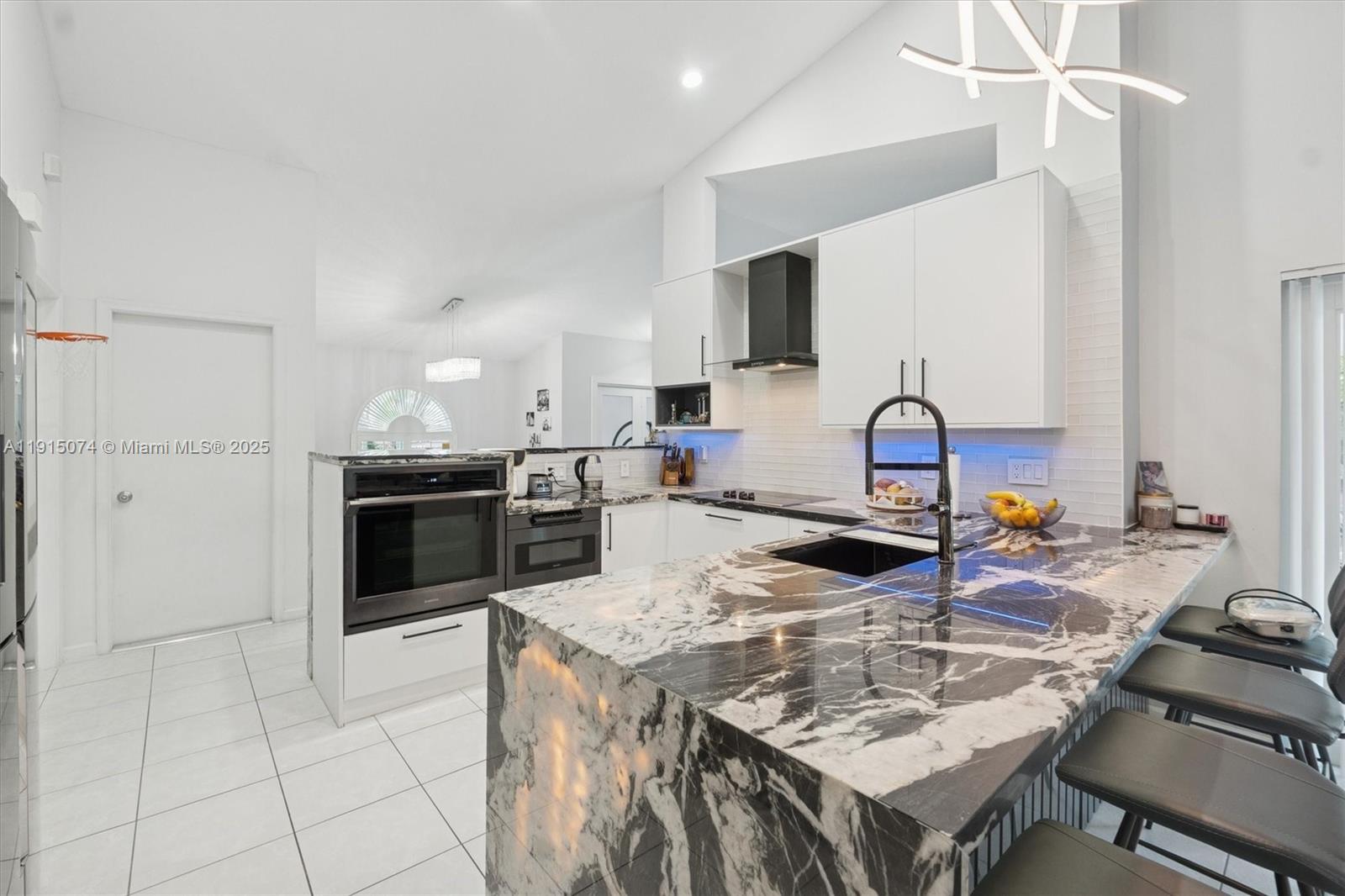 1510 Southwest 96th Terrace Davie, FL 33324 - Photo 10 of 28 a kitchen with a sink a stove and chairs