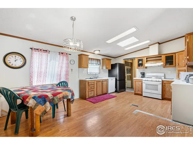 a open kitchen with stainless steel appliances kitchen island granite countertop a sink table and chairs