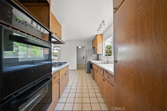 a large kitchen with a stove and a sink
