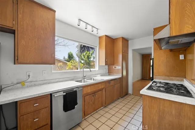 a kitchen with a sink stove and cabinets
