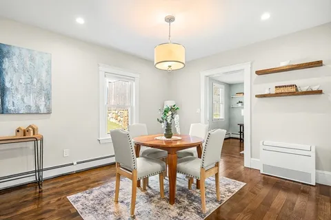 a dining room with furniture and wooden floor