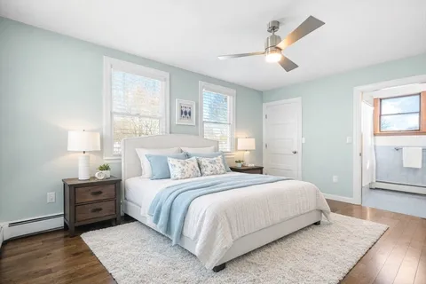 a bedroom with a large bed and a night stand