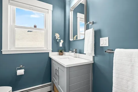 a bathroom with a sink vanity and a mirror