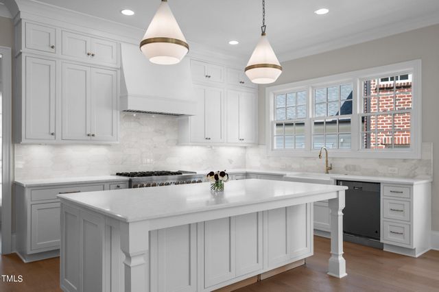 a kitchen with cabinets a sink and appliances
