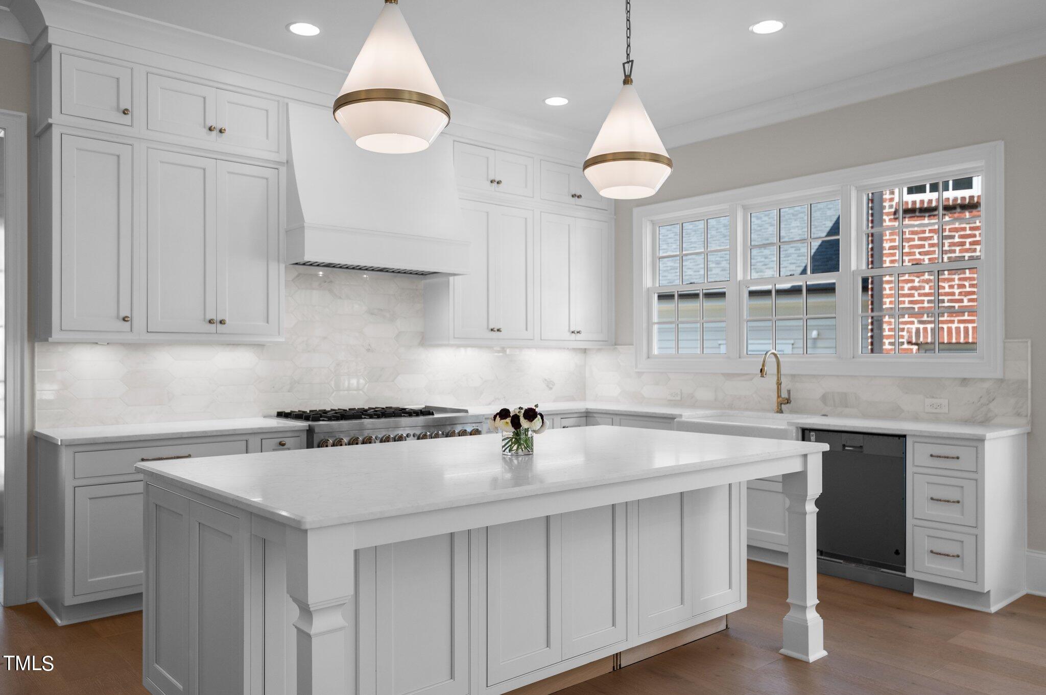 2639 Marchmont Street Raleigh, NC 27608 - Photo 5 of 41 a kitchen with cabinets a sink and appliances
