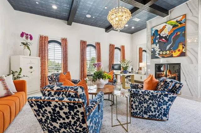a living room with fireplace furniture and a large window