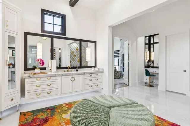 a spacious bedroom with a large bed and a dresser