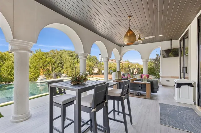 a living room with patio furniture and a large window