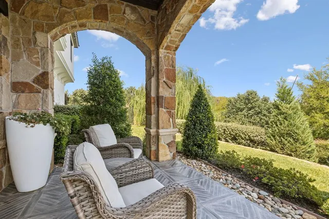a view of a house with swimming pool and sitting area
