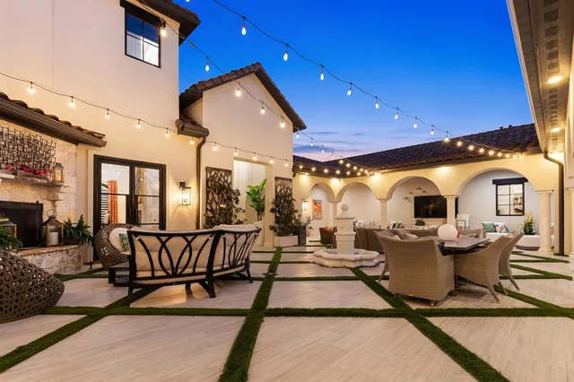 a view of a house with swimming pool and sitting area