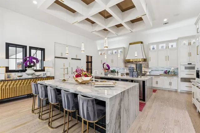 a kitchen with a stove a refrigerator and a dining table