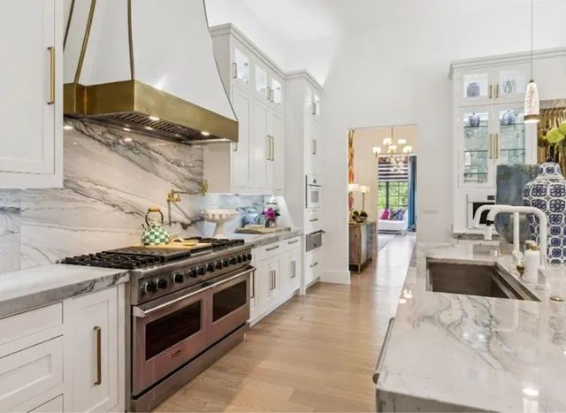a kitchen with stainless steel appliances a stove a sink and a wooden cabinets