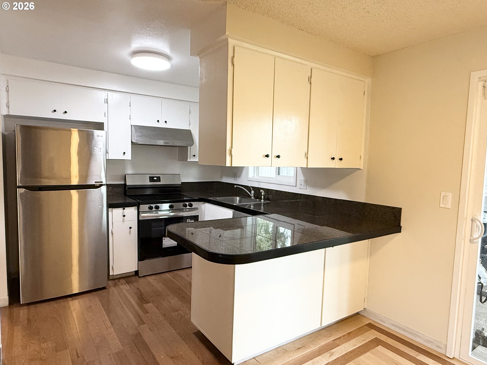5270 Southwest 182nd Avenue Beaverton, OR 97078 - Photo 11 of 35 a kitchen with stainless steel appliances granite countertop a sink stove and refrigerator