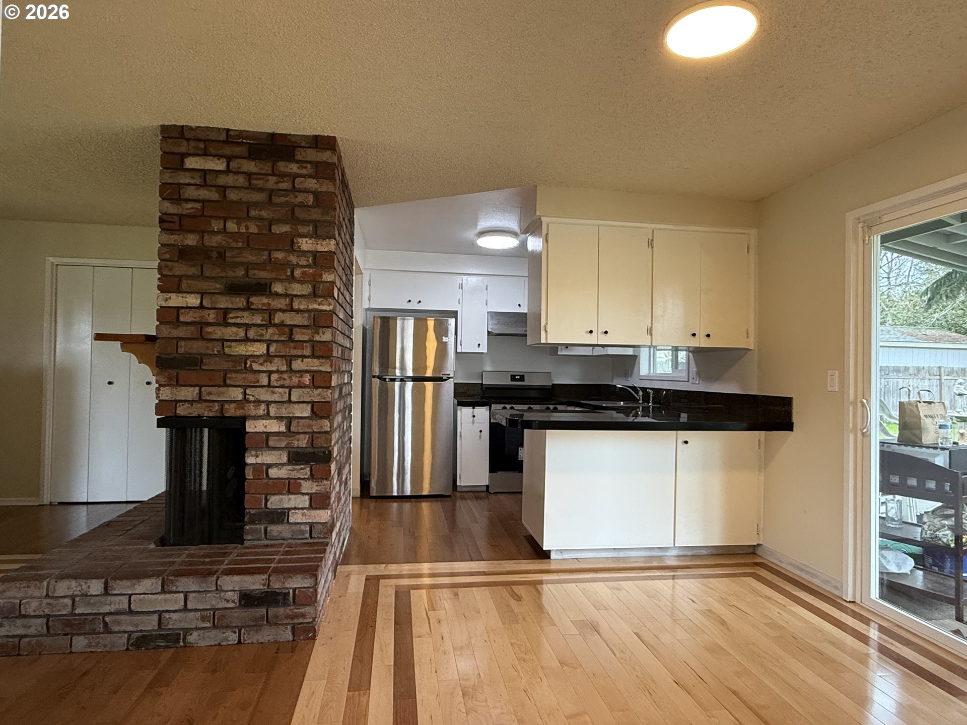 5270 Southwest 182nd Avenue Beaverton, OR 97078 - Photo 13 of 35 a kitchen with kitchen island granite countertop a stove and a sink