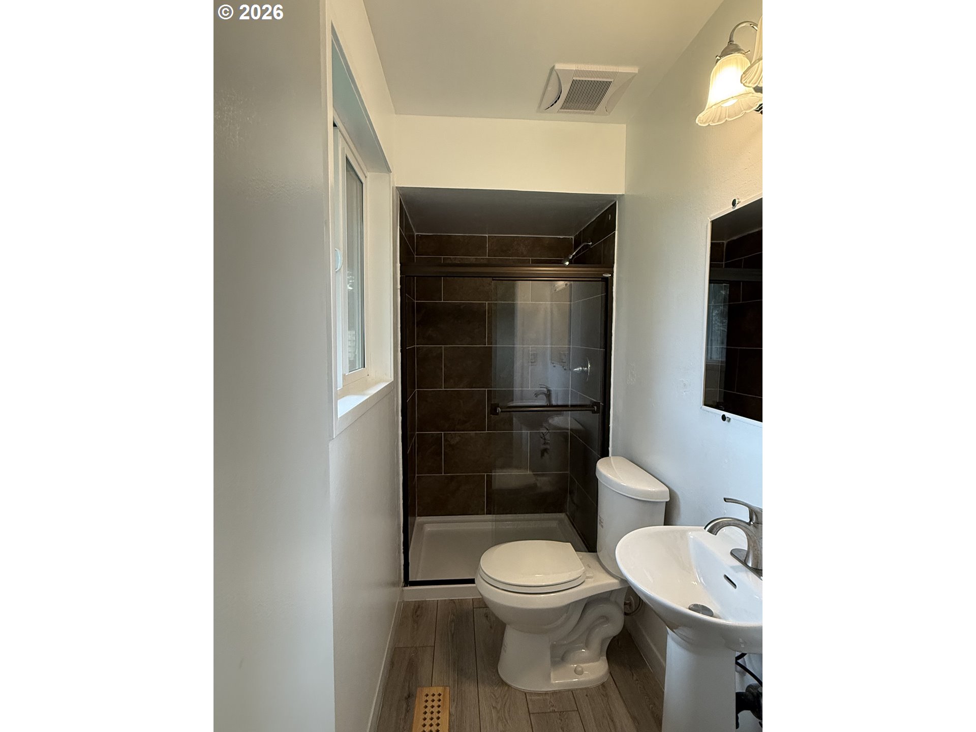 5270 Southwest 182nd Avenue Beaverton, OR 97078 - Photo 22 of 35 a white toilet sitting next to a bathroom sink