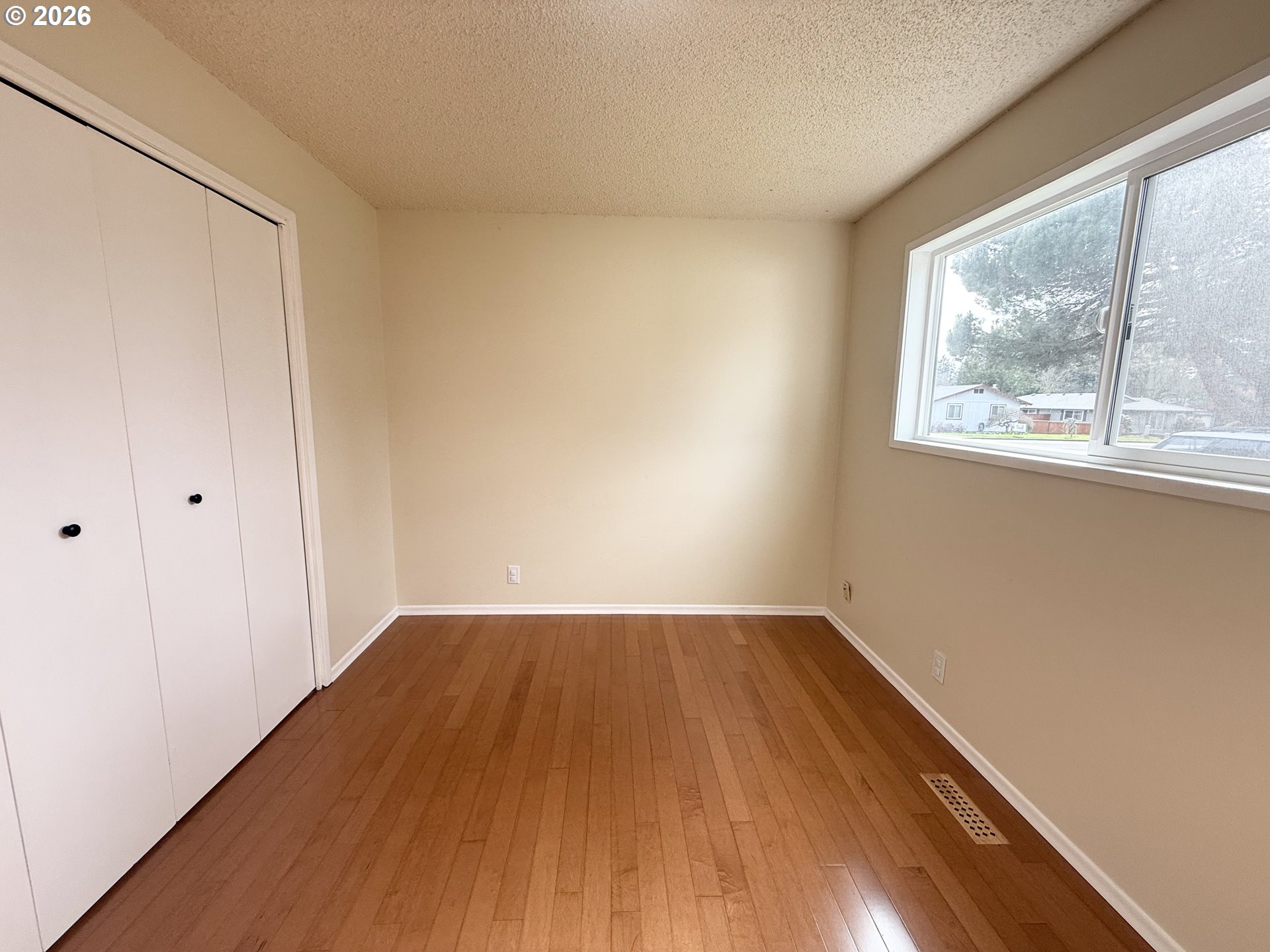 5270 Southwest 182nd Avenue Beaverton, OR 97078 - Photo 23 of 35 an empty room with wooden floor and windows