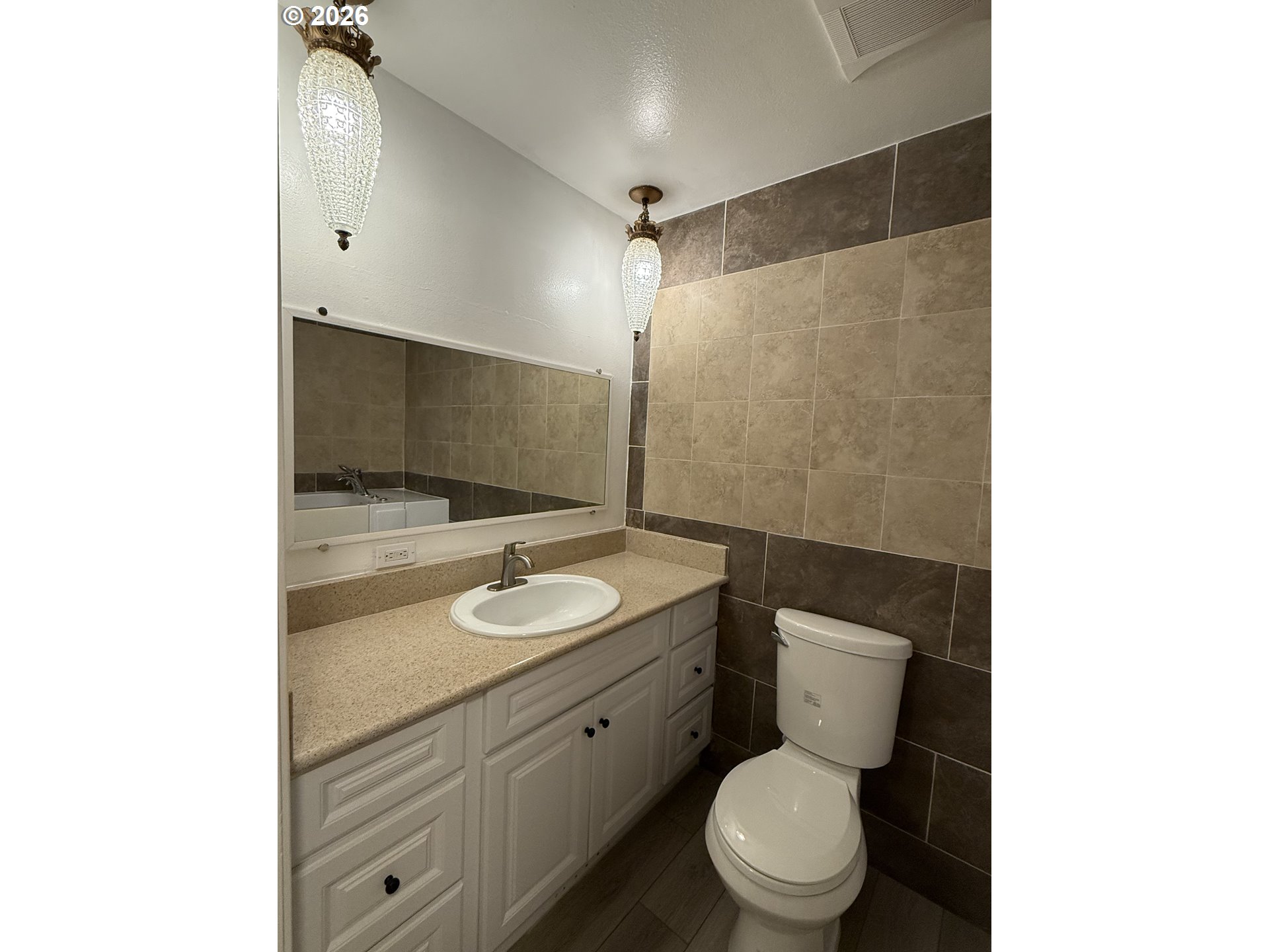5270 Southwest 182nd Avenue Beaverton, OR 97078 - Photo 25 of 35 a bathroom with a toilet sink and a mirror