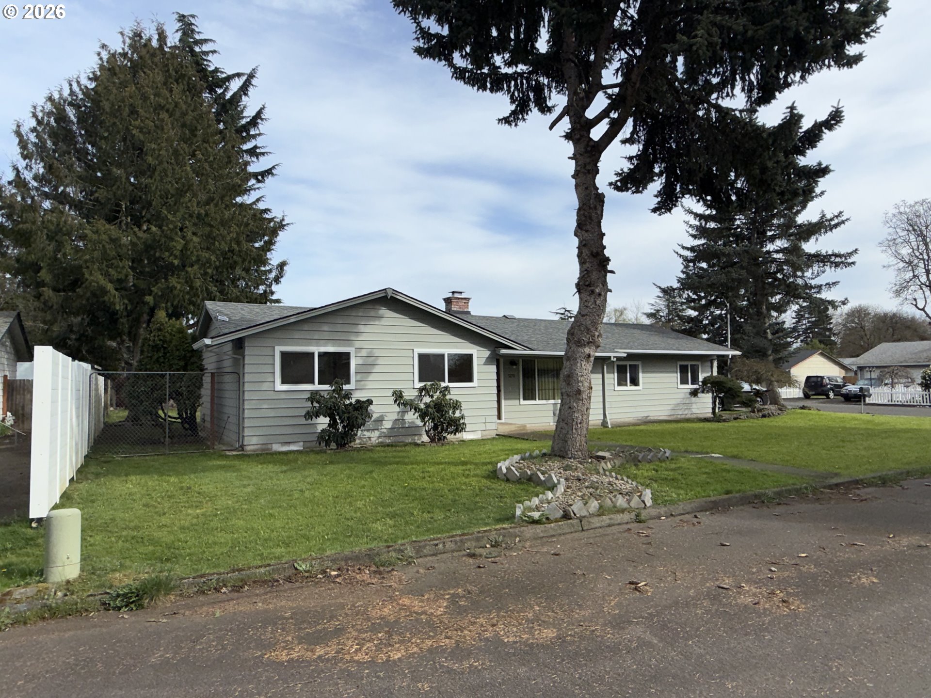 5270 Southwest 182nd Avenue Beaverton, OR 97078 - Photo 4 of 35 a view of a yard in front of a house with large trees