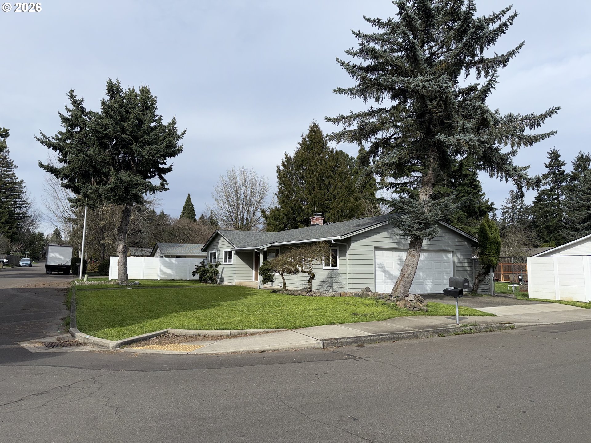 5270 Southwest 182nd Avenue Beaverton, OR 97078 - Photo 5 of 35 a front view of a house with a garden and trees