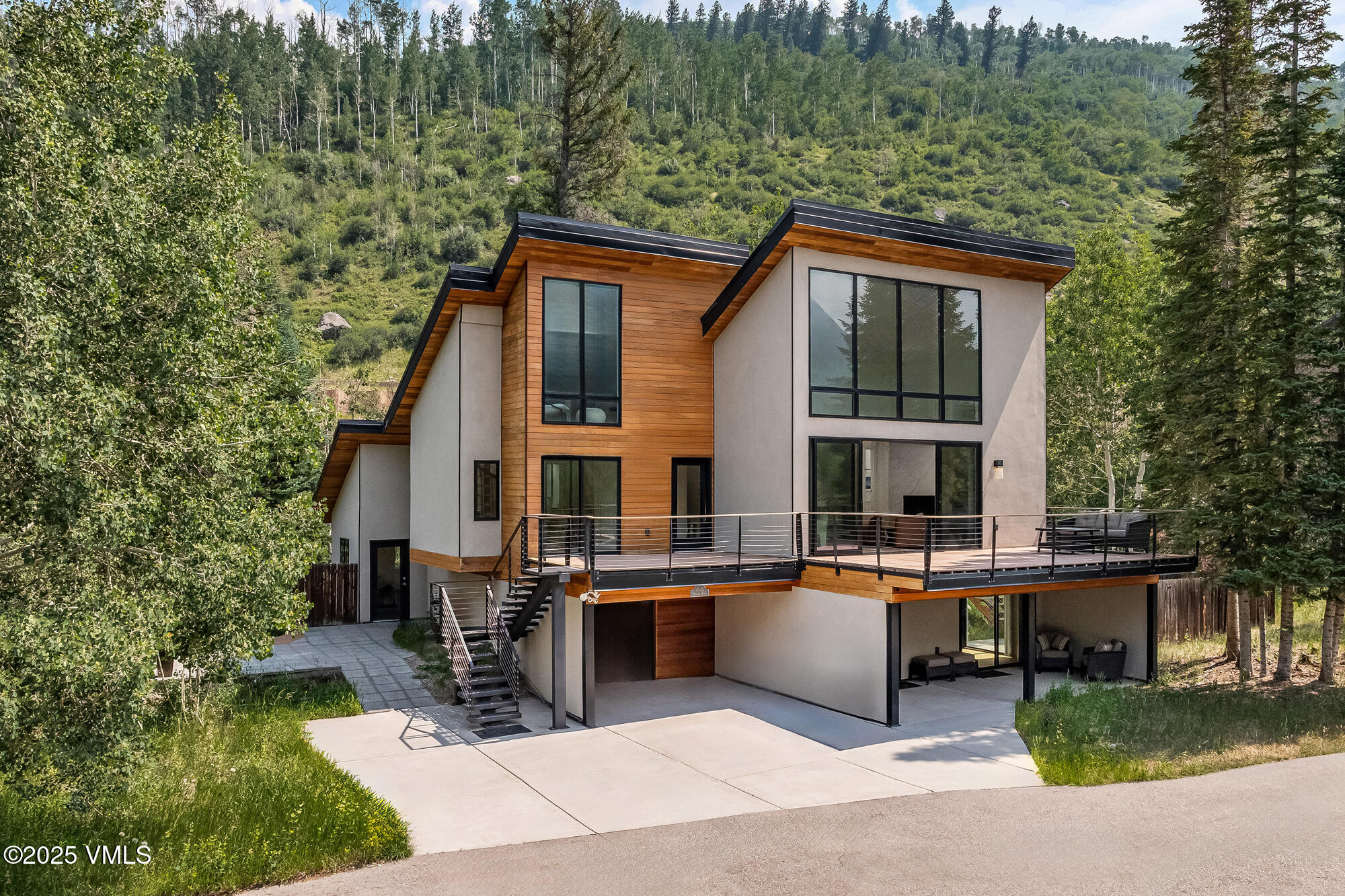 4545 Big Horn Road Vail, CO 81657 - Photo 3 of 49 a backyard of a house with table and chairs