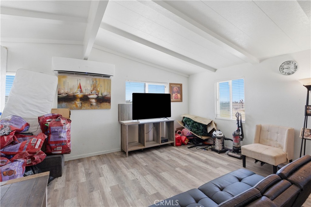 5885 Dos Palmas Road Phelan, CA 92371 - Photo 6 of 40 a living room with furniture and a flat screen tv