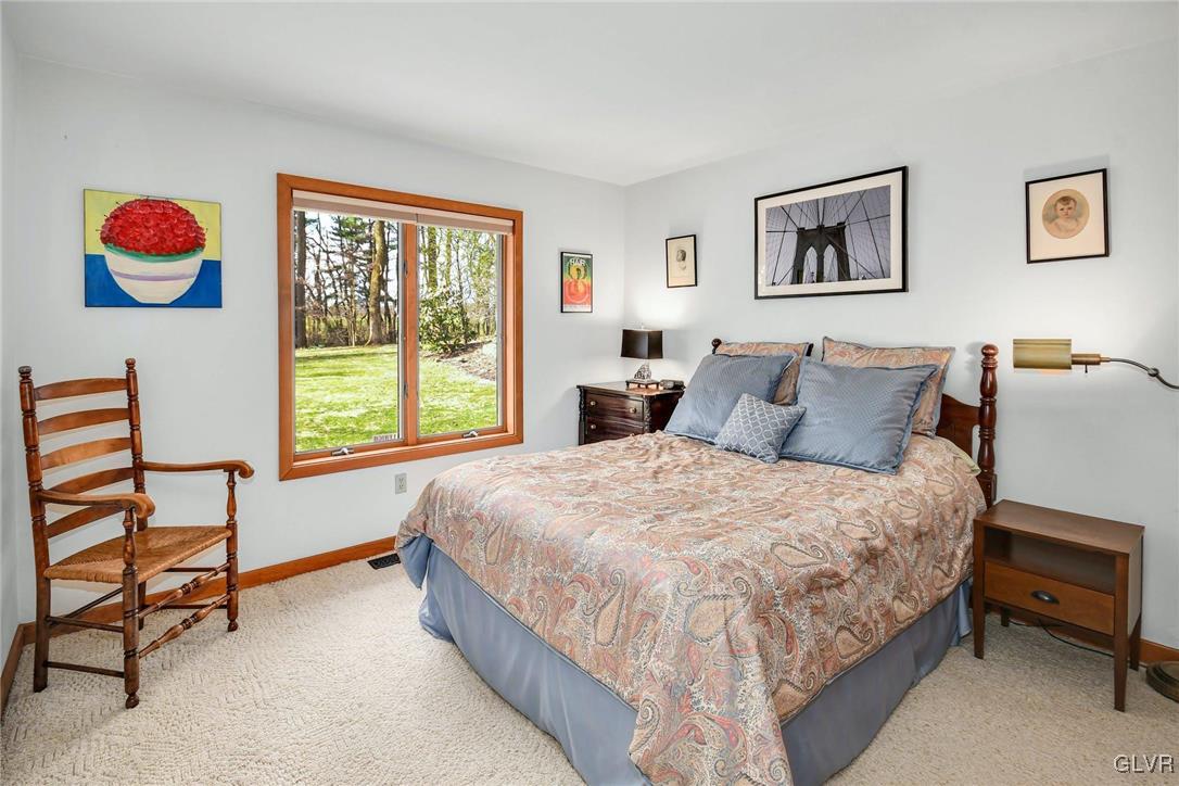 290 Steely Hill Road Riegelsville, PA 18077 - Photo 16 of 33 a bedroom with a bed and dresser next to a window