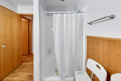 a living room with furniture flat screen tv and a window