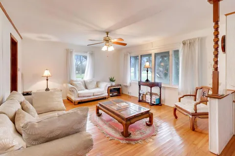 a living room with furniture rug and window