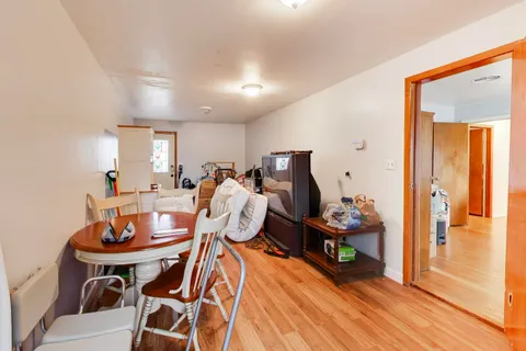 a front view of a house with a garden and trees