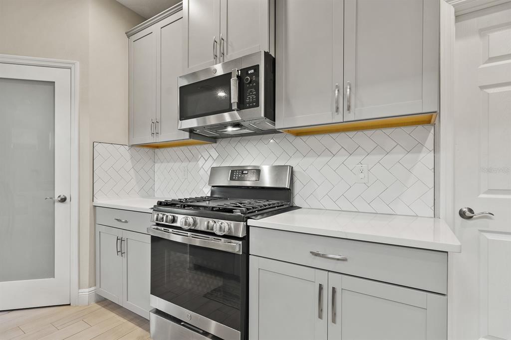 17880 Moon Rise Pass Land O Lakes, FL 34638 - Photo 11 of 43 a kitchen with a stove and a microwave