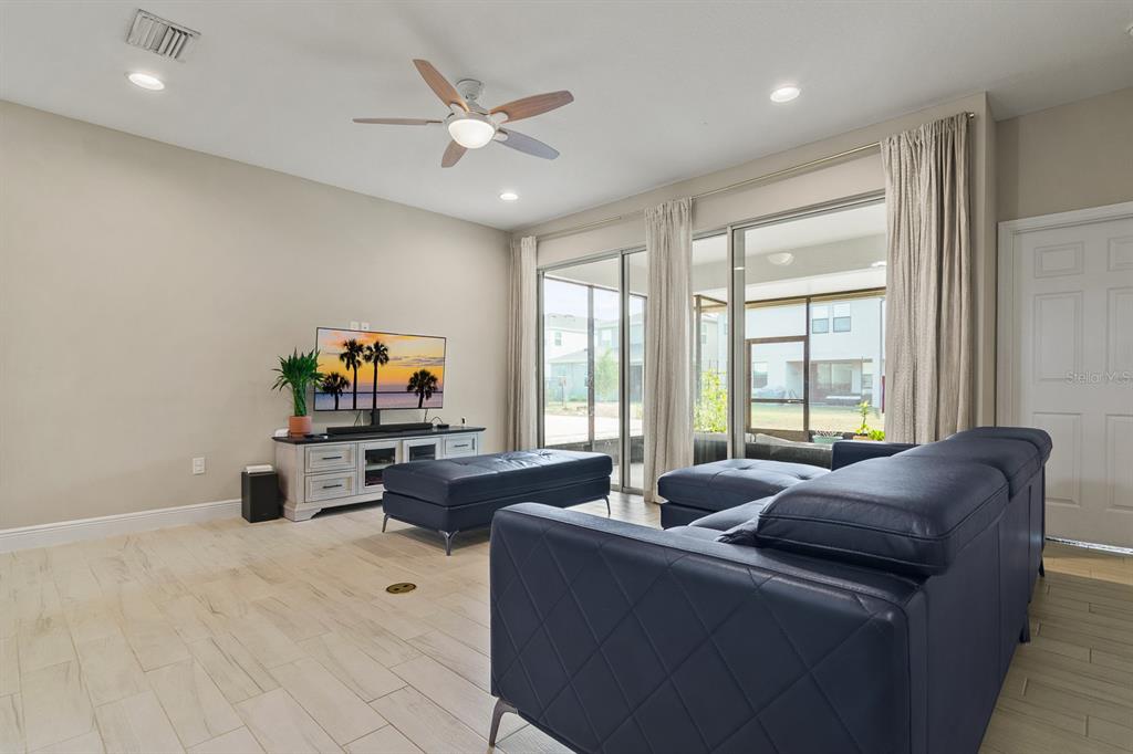 17880 Moon Rise Pass Land O Lakes, FL 34638 - Photo 15 of 43 a living room with furniture and a flat screen tv