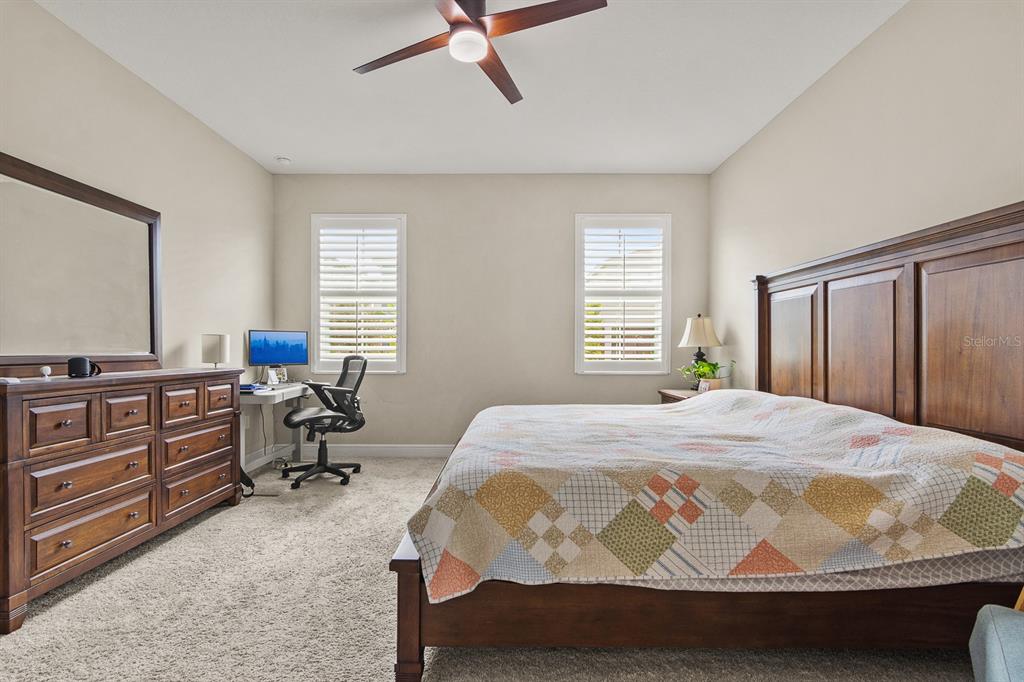 17880 Moon Rise Pass Land O Lakes, FL 34638 - Photo 17 of 43 a bedroom with a bed and wooden floor