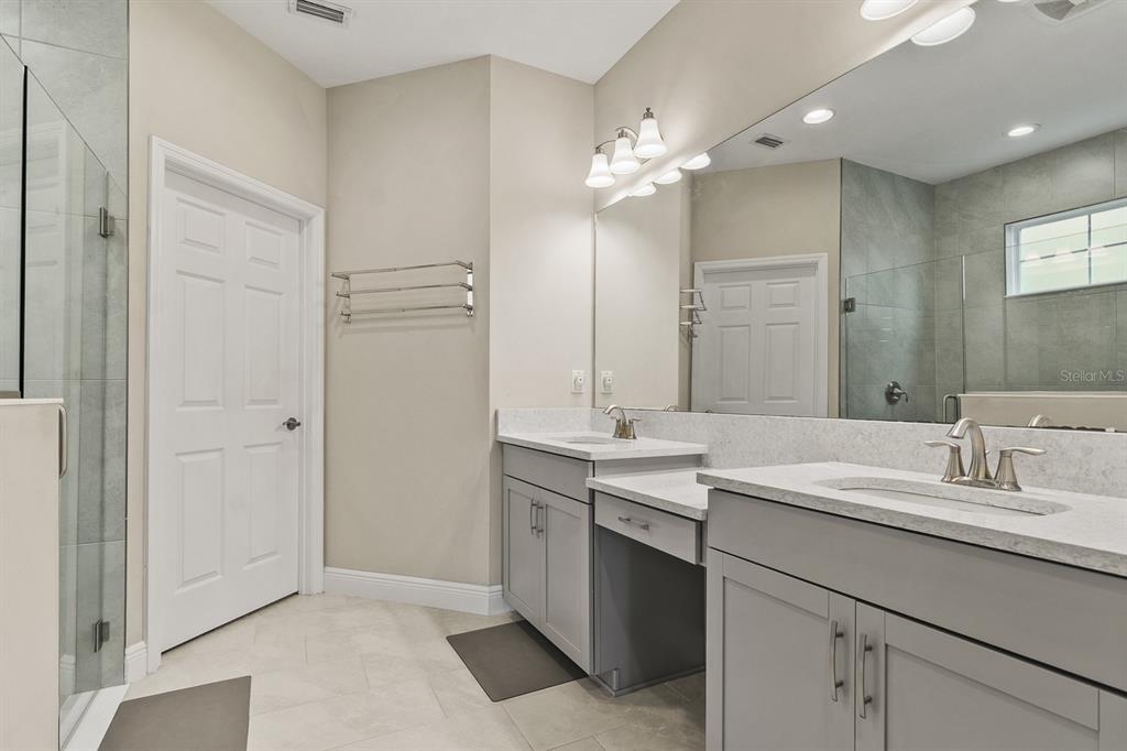 17880 Moon Rise Pass Land O Lakes, FL 34638 - Photo 19 of 43 a bathroom with a sink double vanity and a mirror