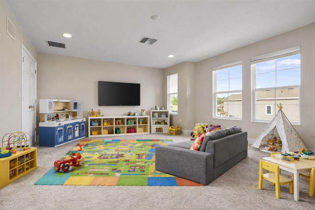 17880 Moon Rise Pass Land O Lakes, FL 34638 - Photo 20 of 43 a living room with furniture flat screen tv and a large window