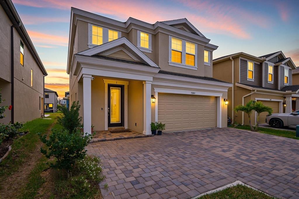 17880 Moon Rise Pass Land O Lakes, FL 34638 - Photo 2 of 43 a front view of a house with a yard and garage