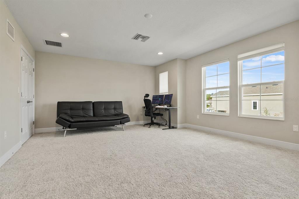 17880 Moon Rise Pass Land O Lakes, FL 34638 - Photo 22 of 43 a living room with furniture and a flat screen tv